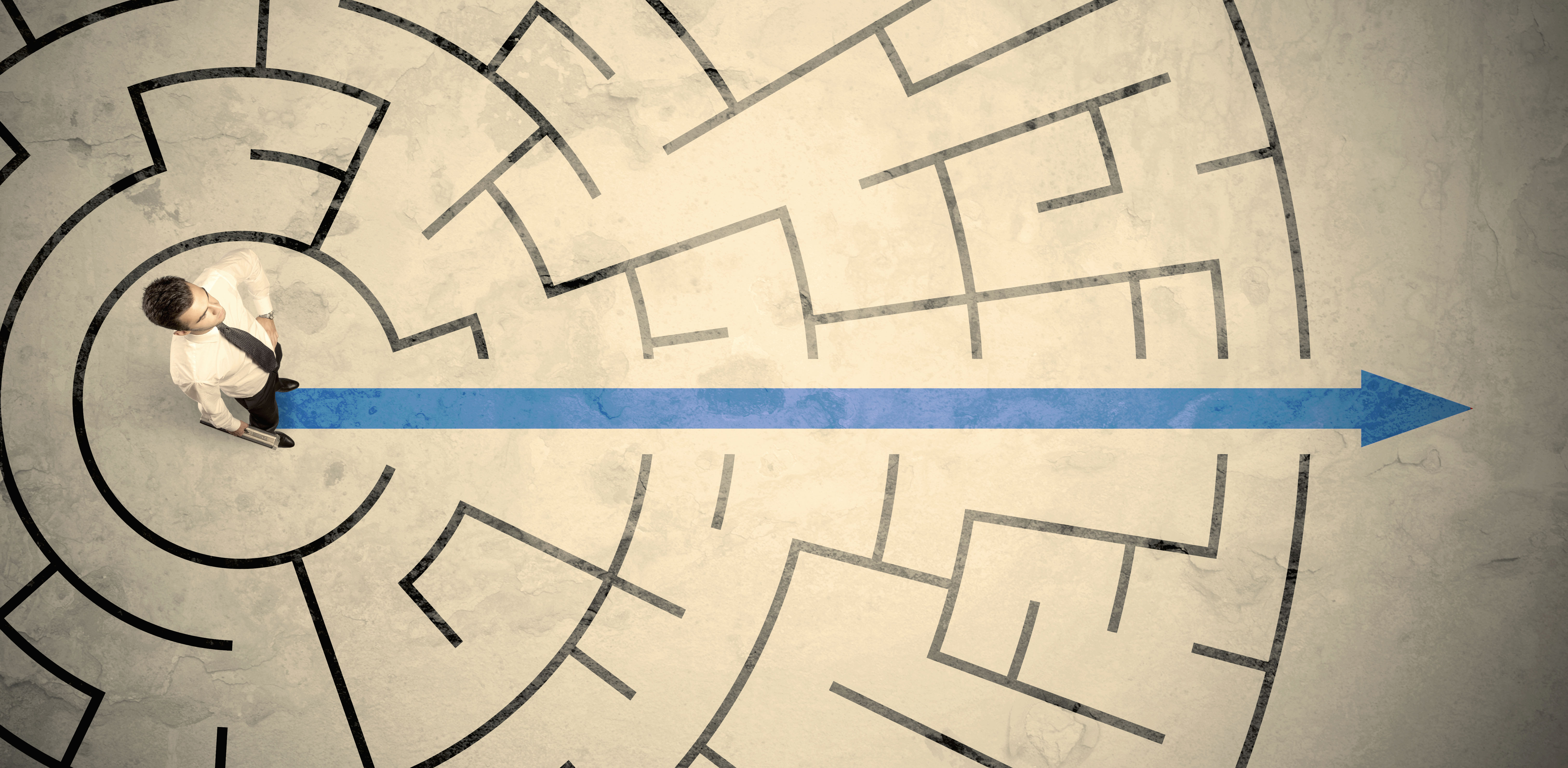 Business person standing in the middle of a circular maze Business person standing in the middle of a circular maze